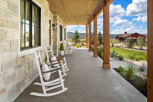 View of patio / terrace with a mountain view and covered porch