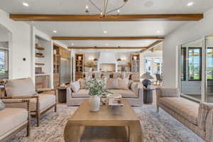 Living room with beamed ceiling and a chandelier