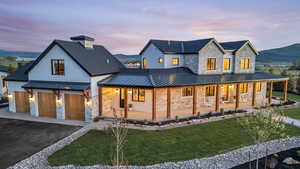 View of front of property with a beautifuyl covered porch and extensive mountain views