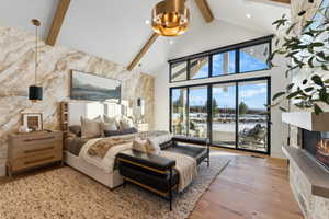 Master Bedroom featuring light hardwood / wood-style flooring, access to outside, high vaulted ceiling, and beamed ceiling