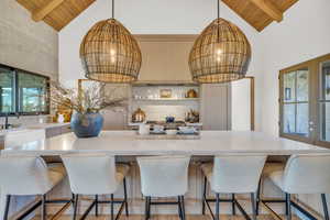 Kitchen featuring hanging light fixtures, a notable chandeliers, and wood ceiling accents