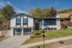 View of front facade with a front yard and a garage