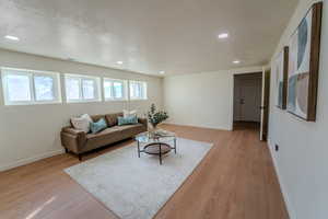 Living room featuring a textured ceiling and light wood-type flooring