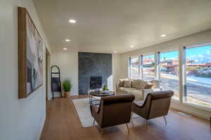 Living room with light hardwood / wood-style flooring and a wealth of natural light