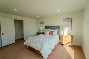 Bedroom with light hardwood / wood-style flooring