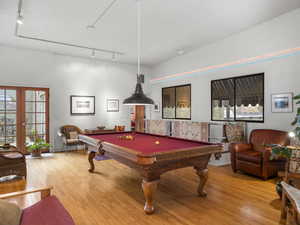 This room is halfway between the first and second level, called 'the pool room'. Billiards table stays.