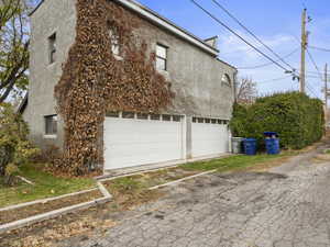 View of property exterior with four car garage.