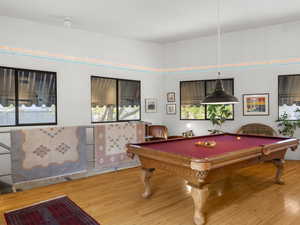 This room is halfway between the first and second level, called 'the pool room'. Billiards table stays.