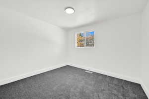 Carpeted spare room with a textured ceiling