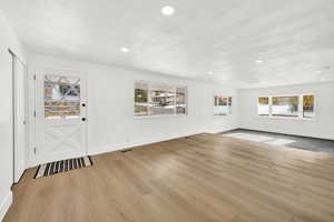 Entrance foyer featuring light wood-style floors and a textured ceiling