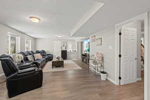 Living room featuring hardwood / wood-style flooring and a textured ceiling