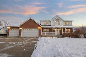 View of front of house with a porch and a garage