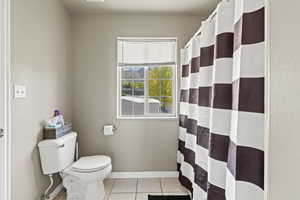 Bathroom with tile patterned flooring and toilet