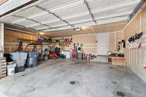 Garage with a workshop area and a garage door opener