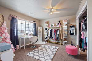 Interior space featuring a textured ceiling and ceiling fan