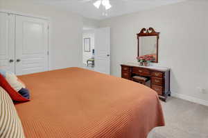 Bedroom featuring carpet floors, a closet, and ceiling fan