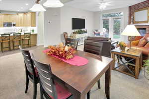 Carpeted dining space featuring french doors and ceiling fan