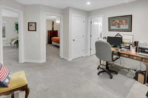 Office space featuring light colored carpet and ceiling fan