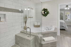 Bathroom featuring ceiling fan and plus walk in shower