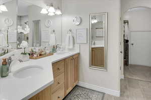 Bathroom with vanity and tiled shower