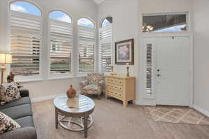 Entrance foyer featuring hardwood / wood-style floors and lofted ceiling