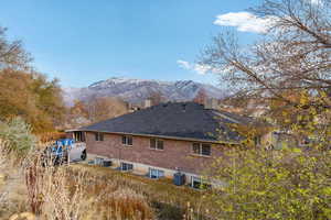 Rear view of property with a mountain view and central air condition unit