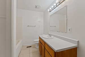 Bathroom with tile patterned floors, vanity, and toilet