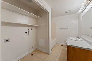 Full bathroom with tile patterned flooring, vanity, toilet, and tub / shower combination