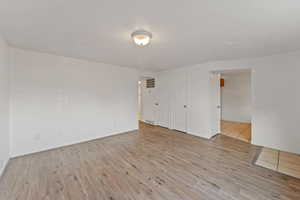 Empty room featuring light hardwood / wood-style flooring and a textured ceiling