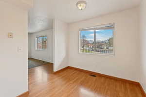 Spare room featuring wood-type flooring and a textured ceiling