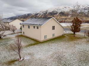 View of side of home with a mountain view