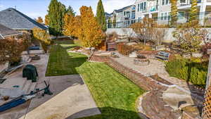 View of yard with a fire pit and a patio area