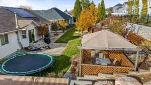 View of yard with a patio area and a trampoline