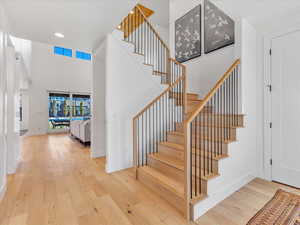 Entryway with hardwood / wood-style floors and a high ceiling