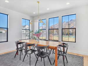 Dining area with a mountain view and wood-type flooring