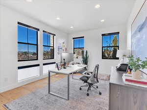 Home office with hardwood / wood-style flooring