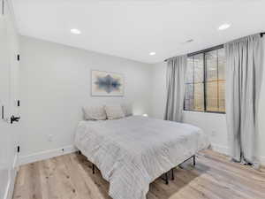 Bedroom with light hardwood / wood-style floors