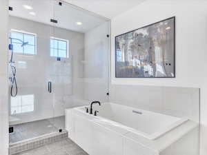 Bathroom with tile patterned flooring and plus walk in shower