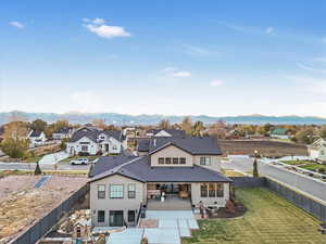 Rear view of house featuring a lawn and a mountain view