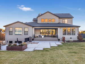 Back of property featuring an outdoor hangout area, a yard, and a patio