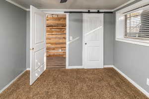 Unfurnished bedroom with carpet, ceiling fan, and a closet