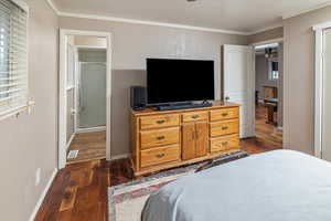 Bedroom featuring dark hardwood / wood-style flooring and ornamental molding