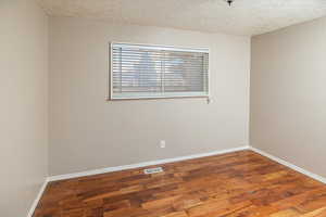 Upstairs bedroom with wood-style floors