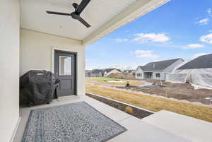 View of patio / terrace with grilling area, a residential view, and a ceiling fan