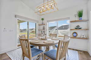 Dining room featuring a wealth of natural light, baseboards, and wood finished floors