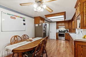 Kitchen featuring stainless steel appliances, light hardwood / wood-style flooring, ceiling fan, and sink