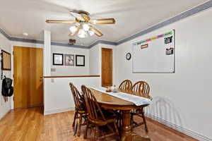 Dining room featuring ceiling fan and light hardwood / wood-style floors