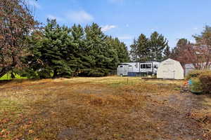 View of yard with a storage shed