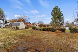 View of yard with a storage shed