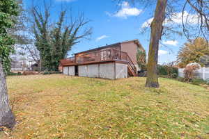 View of yard featuring a wooden deck